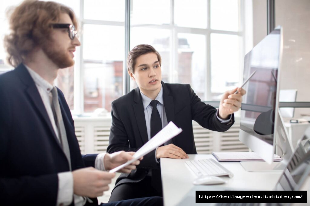 Law firm partners reviewing digital marketing analytics with an SEO agency during a strategy meeting focused on lead generation and ROI